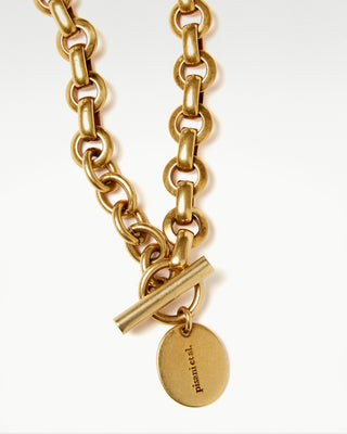 close up view of the gold plated brass bembo egg necklace|light