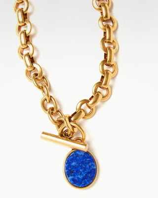 close up view of the gold plated brass bembo egg necklace with lapis lazuli semi precious stone|light