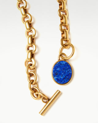 detail view of the gold plated brass bembo egg necklace with lapis lazuli semi precious stone|light