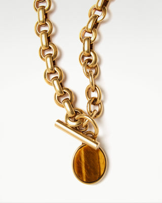 detailed view of the gold plated brass bembo egg necklace with tiger eye semi precious stone|light