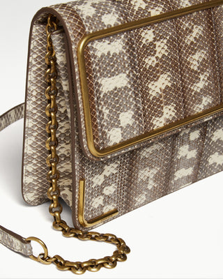detailed view of the White gala exotic snake skin satchel bag and gold-plated chain and hardware|light