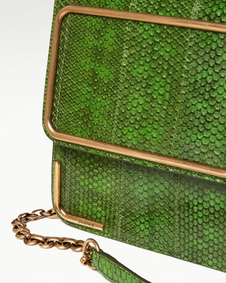 detailed view of green gala exotic snake skin satchel bag and gold-plated hardware and chain|light