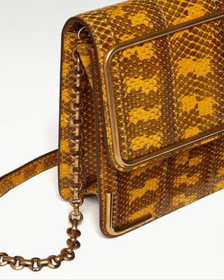 detailed view of the yellow gala exotic snake skin satchel bag and gold plated chain and hardware|light
