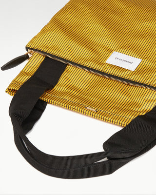 detailed view of the yellow pietro silk tote with zippered pouch|light
