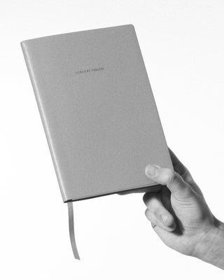holding the octavo leather bound journal|light
