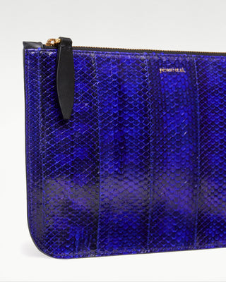 detail view of the blue vanni exotic snake skin pouch with a pocket|light