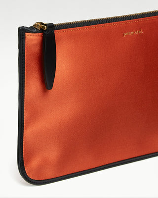 detailed view of the orange vanni silk zippered pouch with a pocket|light
