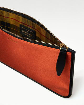 inside view of the orange vanni silk zippered pouch with a pocket|light