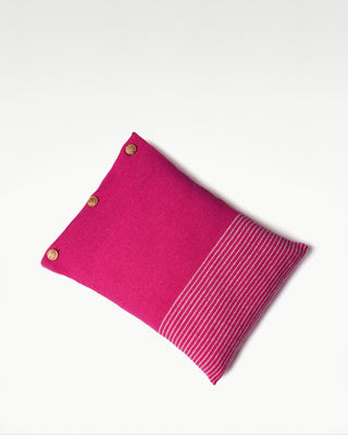 front view of the pink small striped dolce cashmere travel pillow with olive wood buttons|light